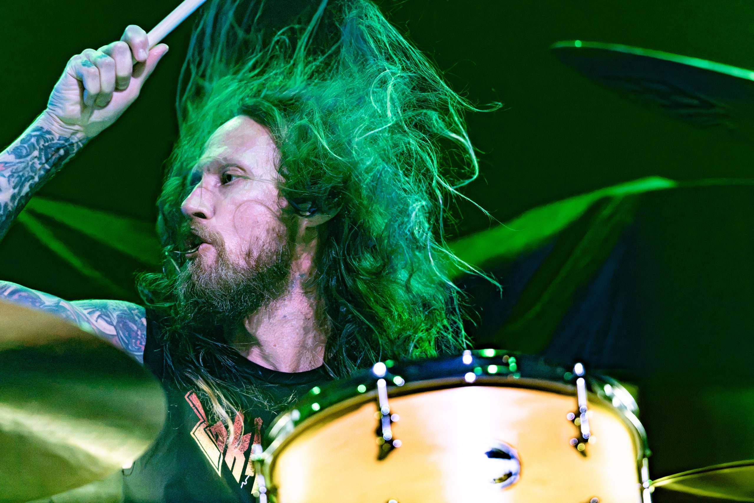 Zakk Sabbath drummer performing under green stage lights