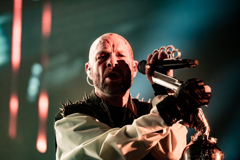 Ivan Moody singing into a microphone during Five Finger Death Punch at Coastal Credit Union Music Park in Raleigh on October 14, 2026.