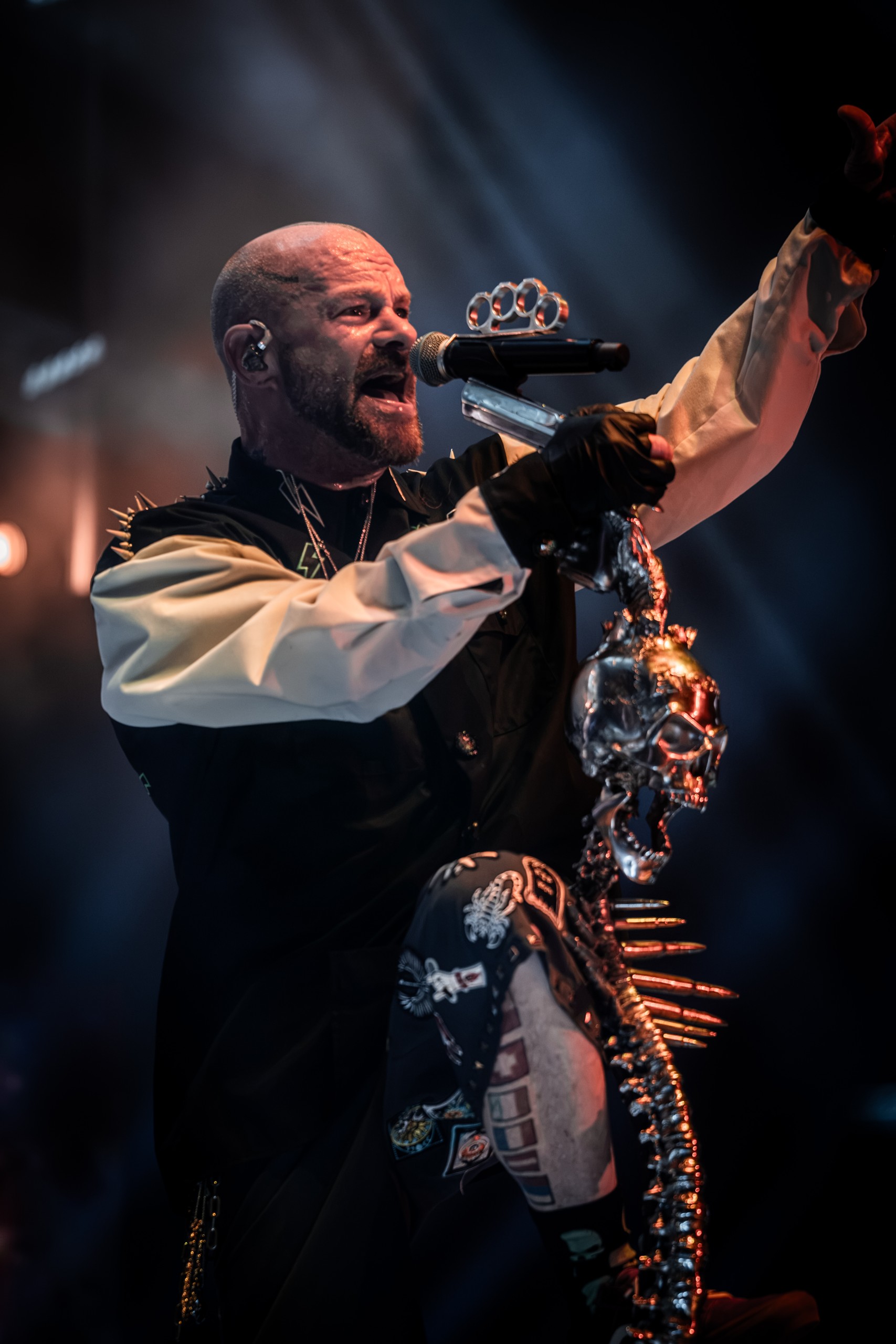 Ivan Moody raising his arm while singing to the crowd. Five Finger Death Punch at Coastal Credit Union Music Park, Raleigh, October 14, 2026.