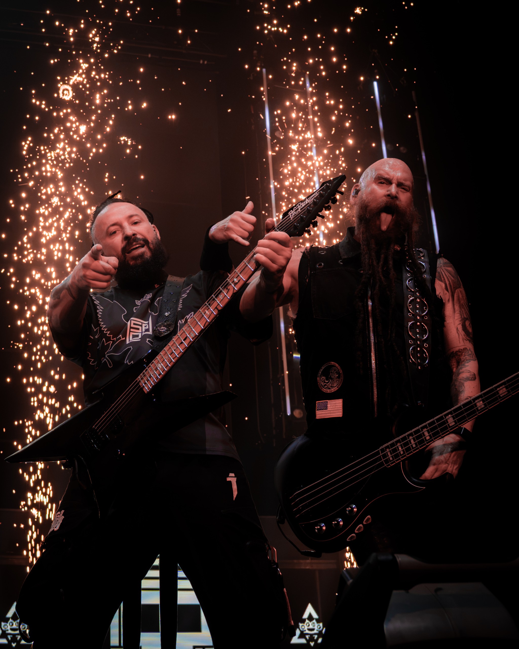 Five Finger Death Punch members performing in front of a shower of stage sparks. Five Finger Death Punch at Coastal Credit Union Music Park, Raleigh, October 14, 2026.