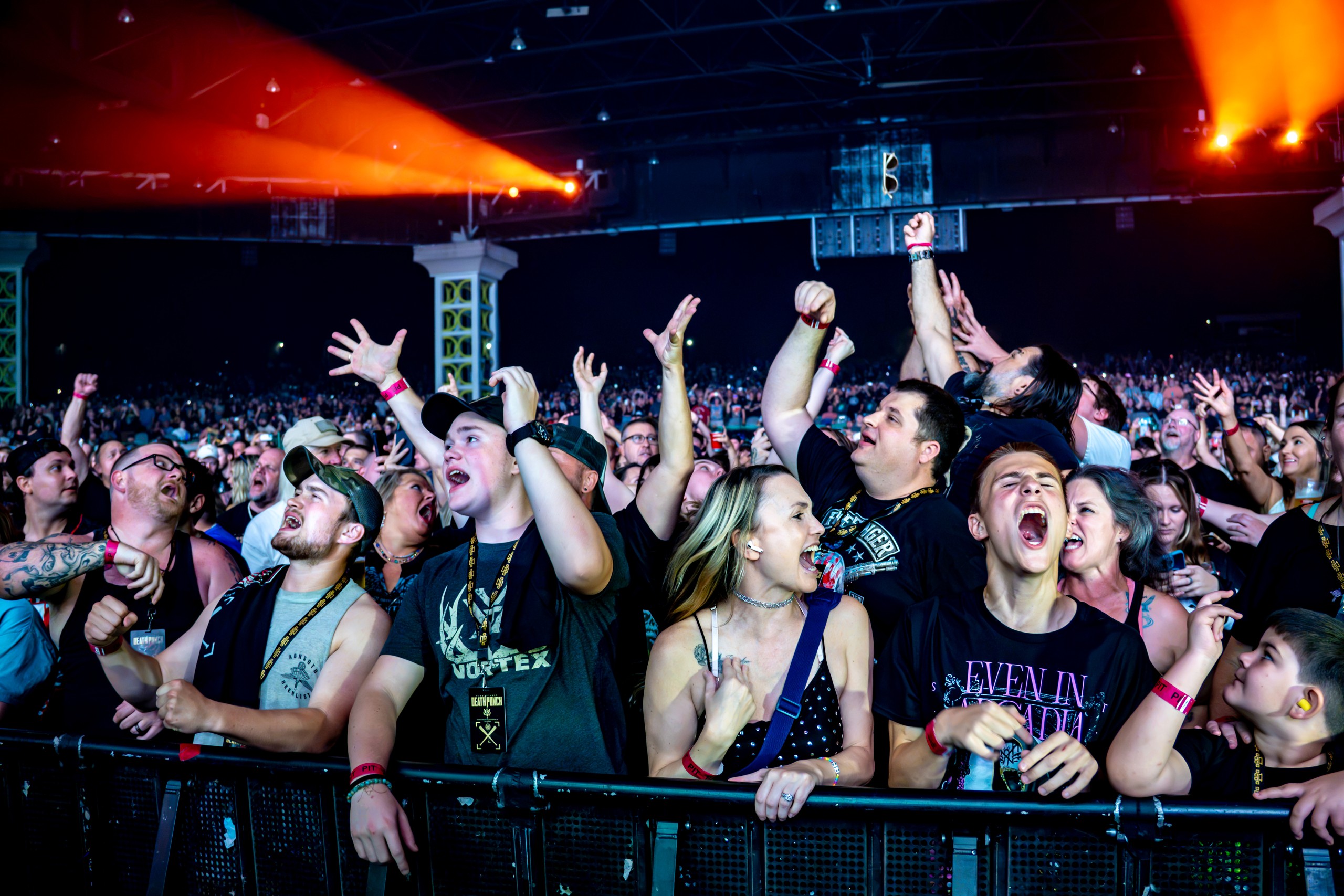 Fans cheering and reaching toward the stage from the barricade. Five Finger Death Punch at Coastal Credit Union Music Park, Raleigh, October 14, 2026.