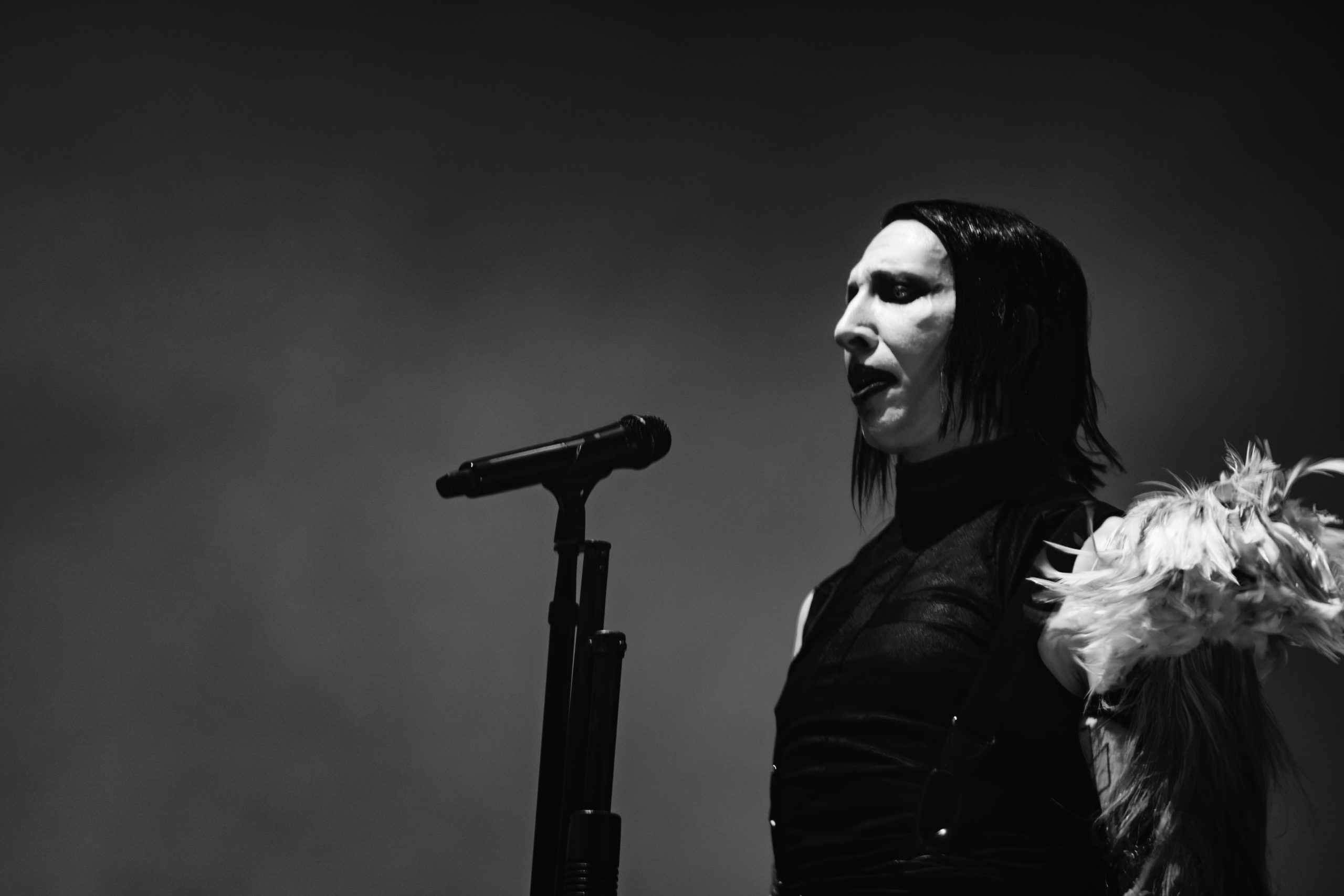 Marilyn Manson singing into a microphone on stage, photographed by Jonathan J. Hall