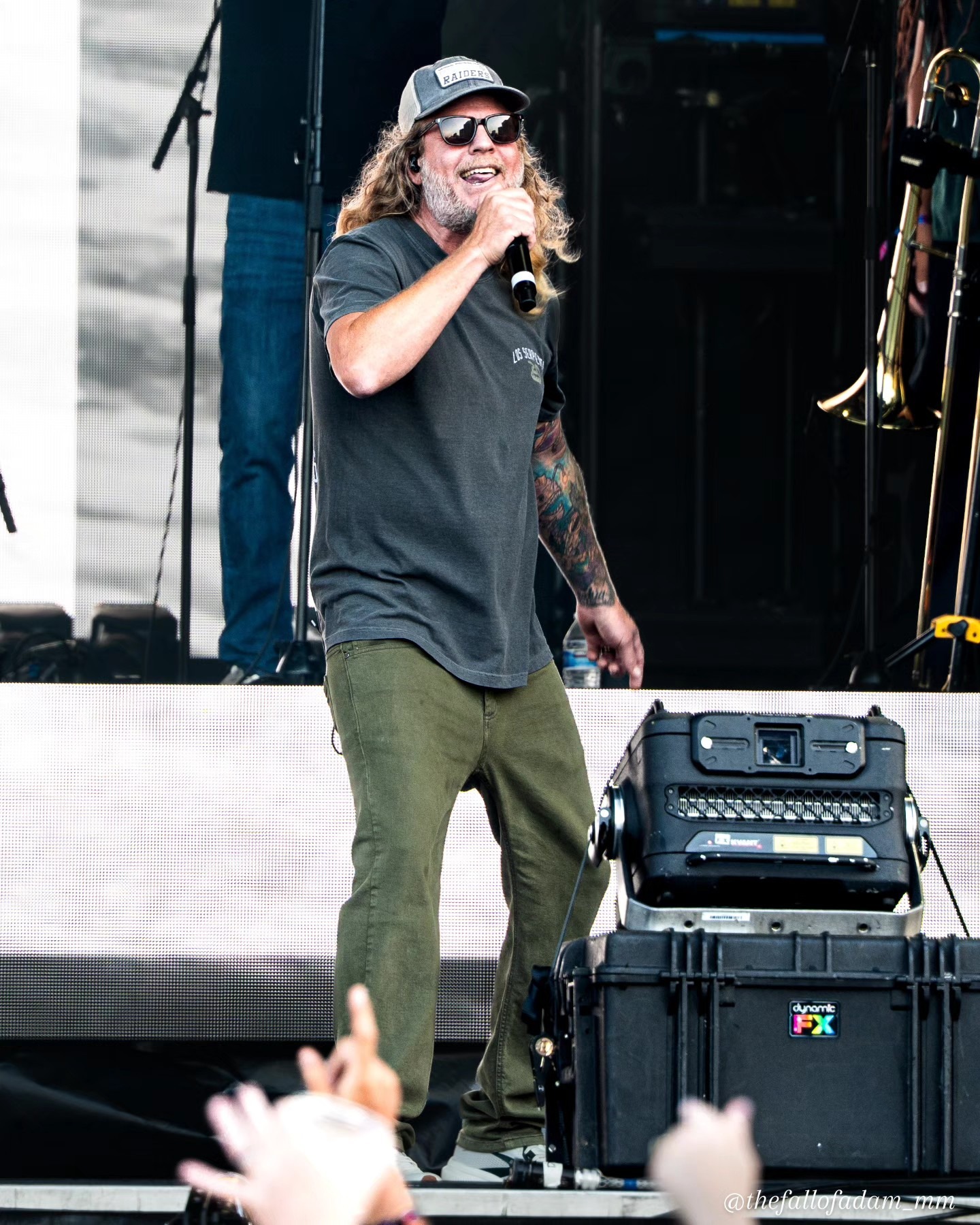 Dirty Heads vocalist singing in sunglasses.