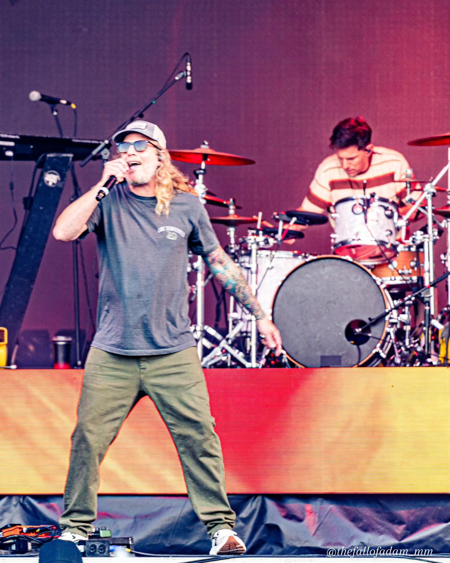 Dirty Heads vocalist performing beside the drummer.