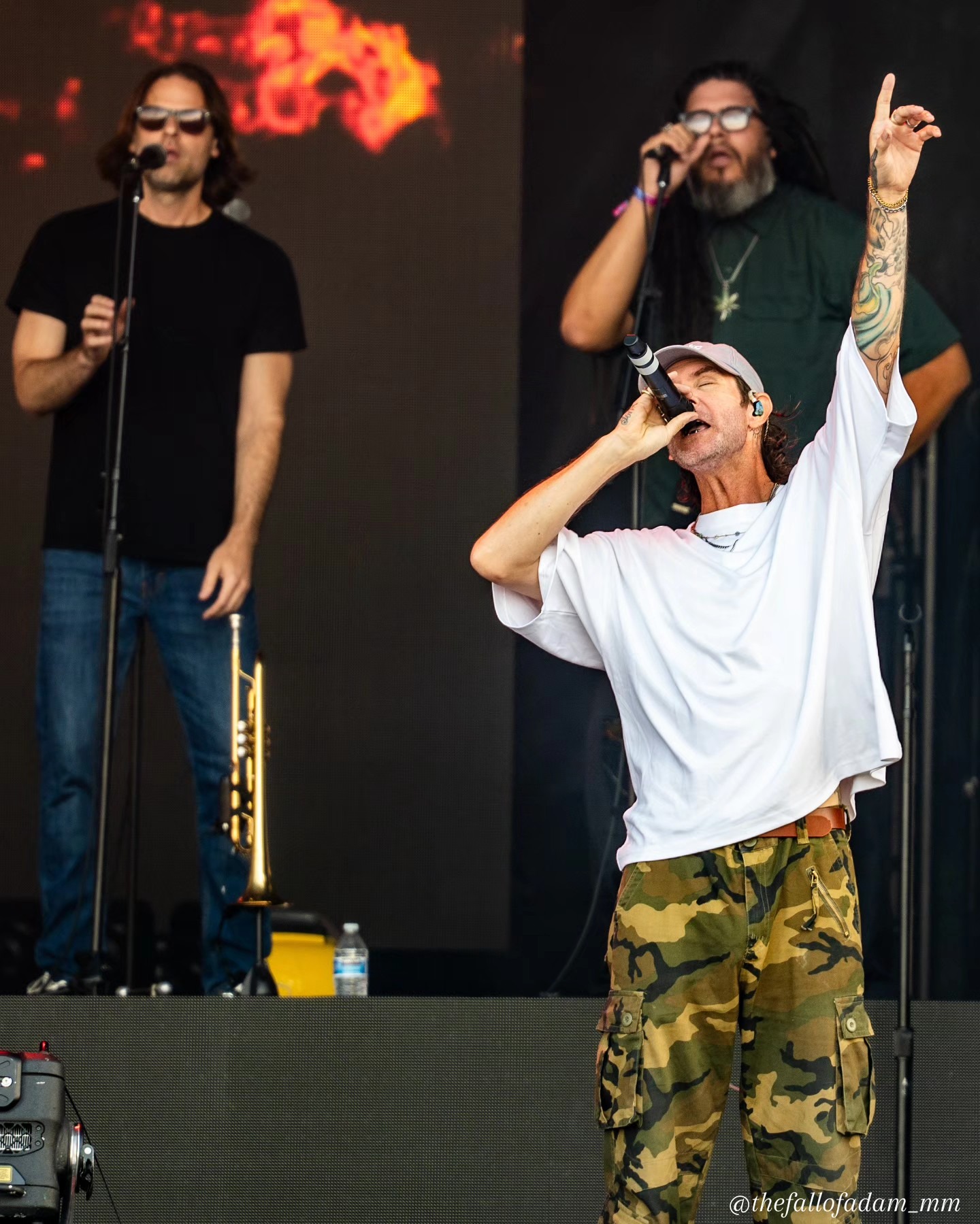 Dirty Heads musicians performing together against warm stage screens.