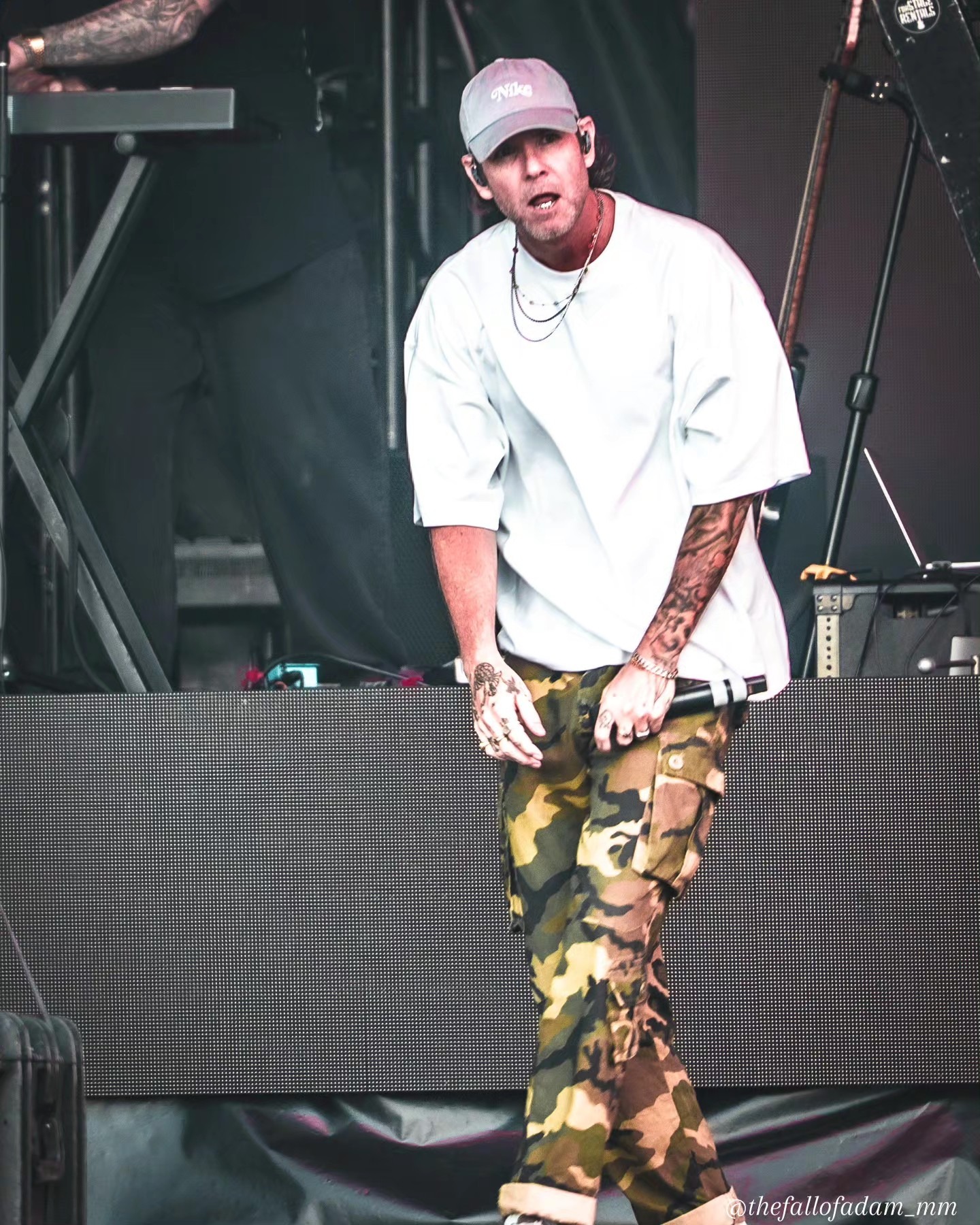 Dirty Heads vocalist standing at the front of the stage.