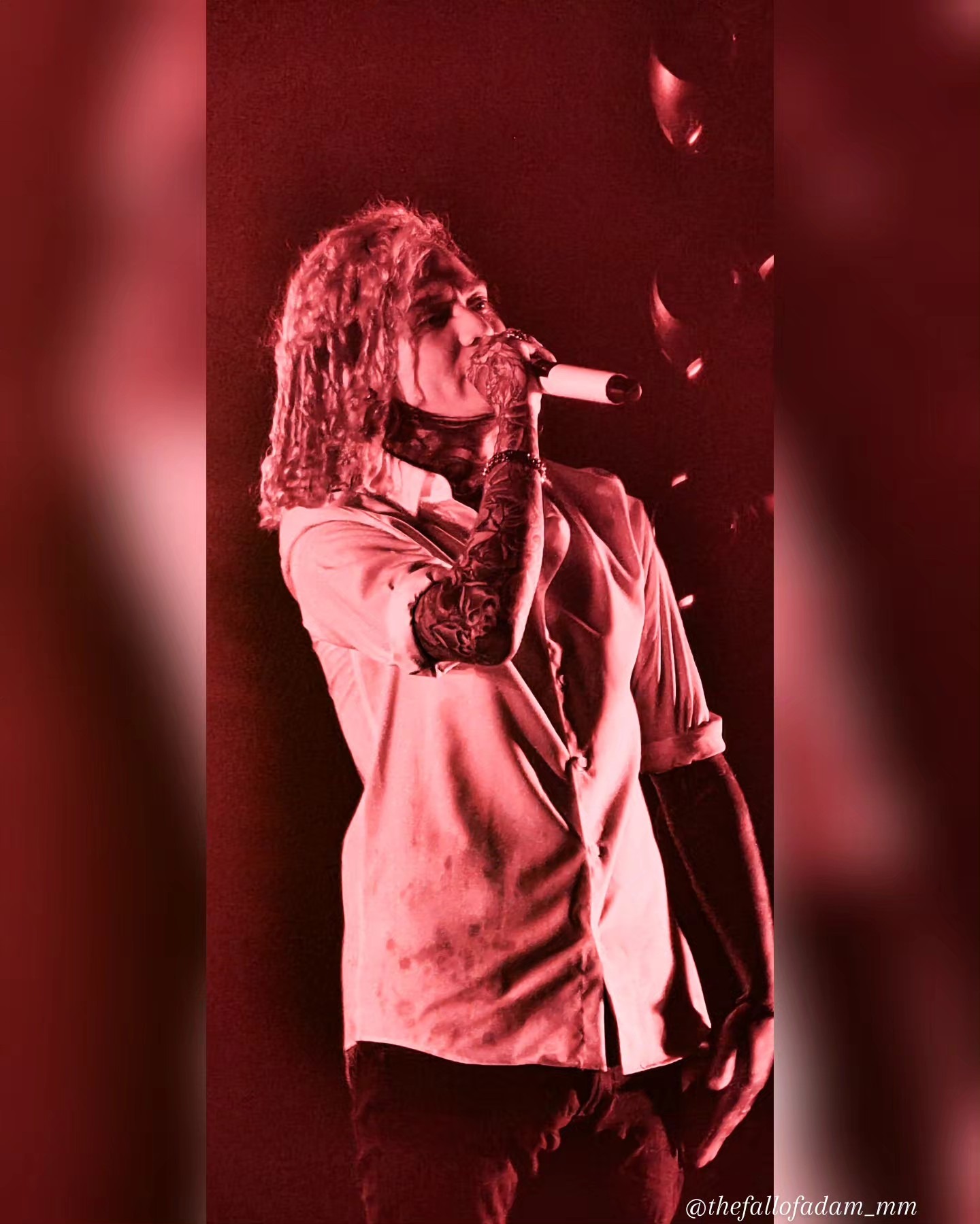 Close view of Lorna Shore vocalist singing in red light.
