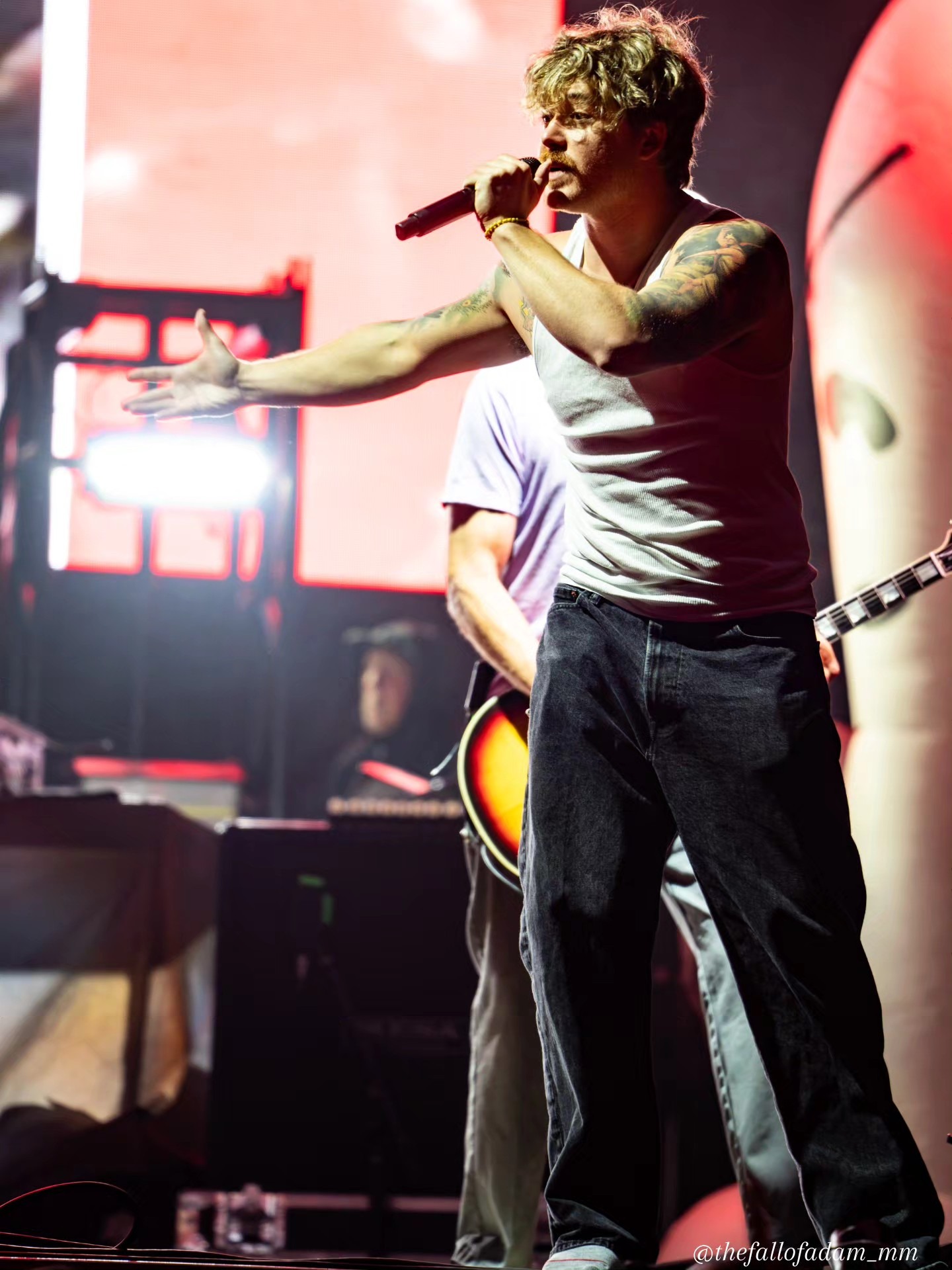 Sublime vocalist extending his arm toward the crowd.