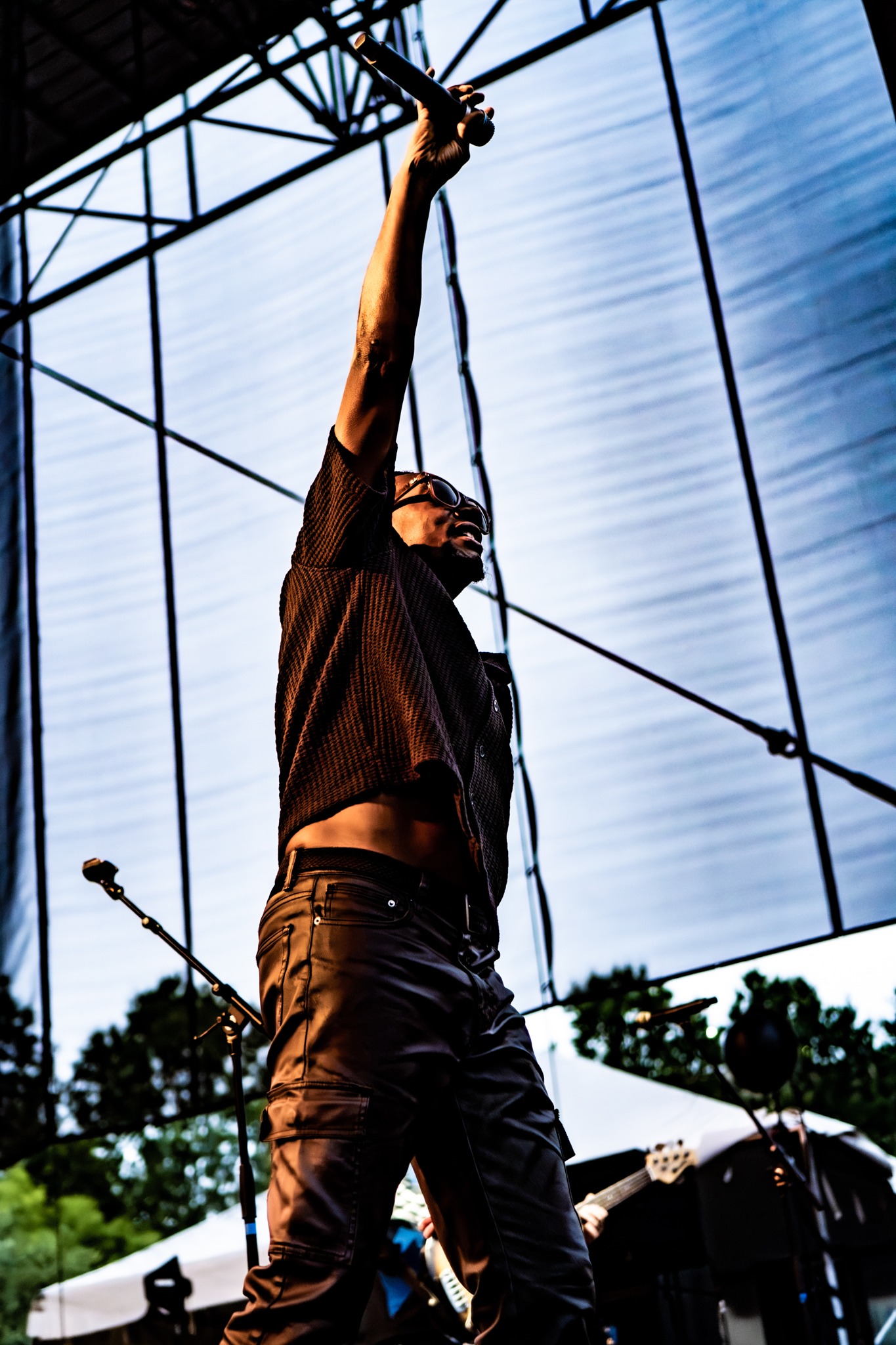 Tribal Seeds vocalist reaching upward at the microphone.
