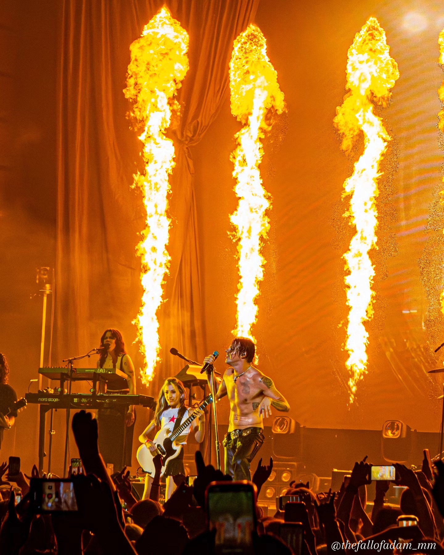 Columns of flame rising behind Yungblud and the band.