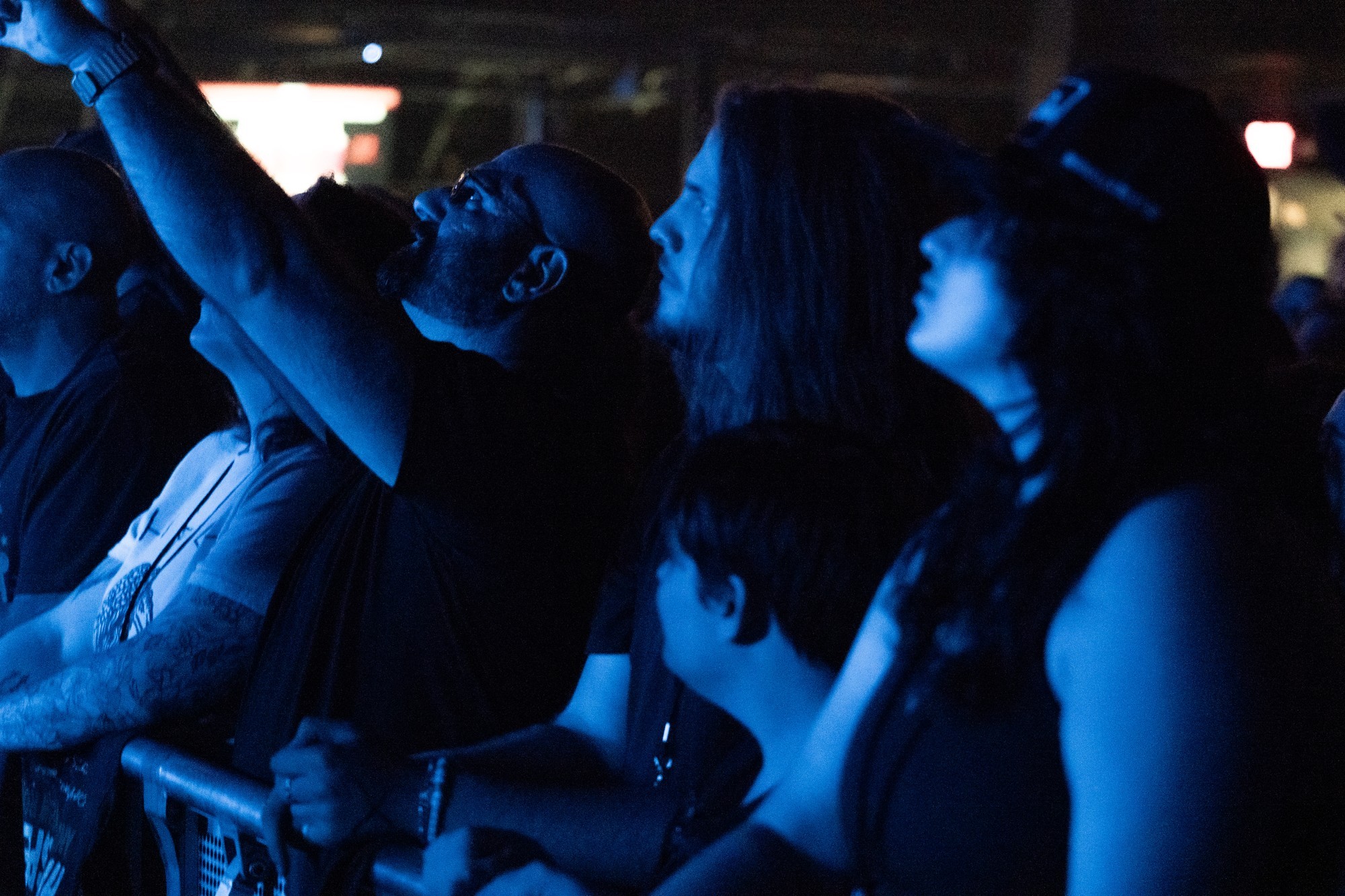 Dead Poet Society musicians leaning over the front of the stage.