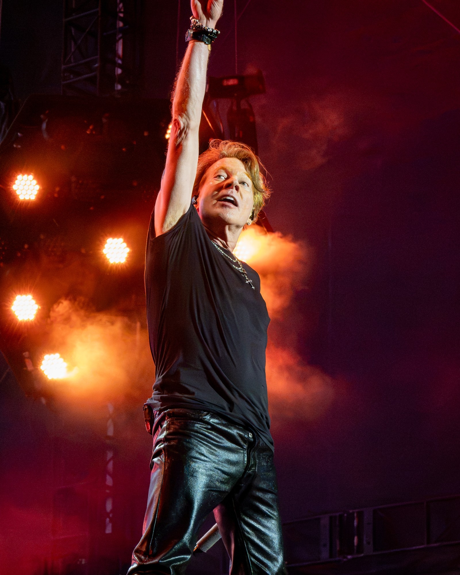 Axl Rose raising his hand toward the audience.