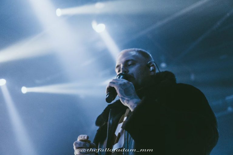 Highly Suspect vocalist singing under blue and white stage lights at The Ritz.