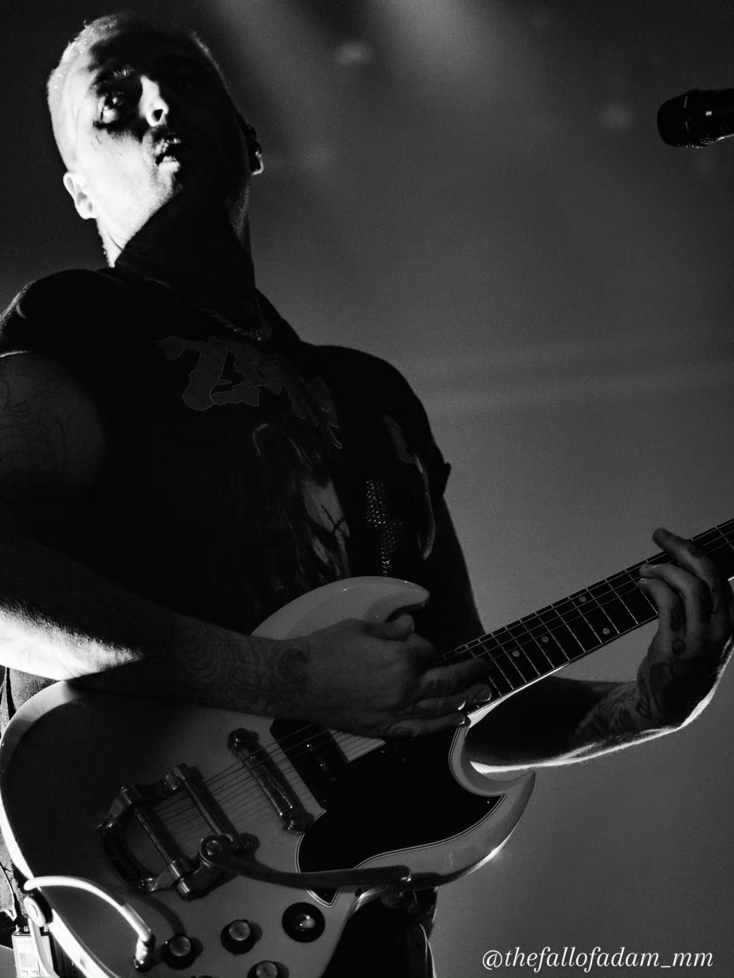 Black and white portrait of a Highly Suspect guitarist onstage.
