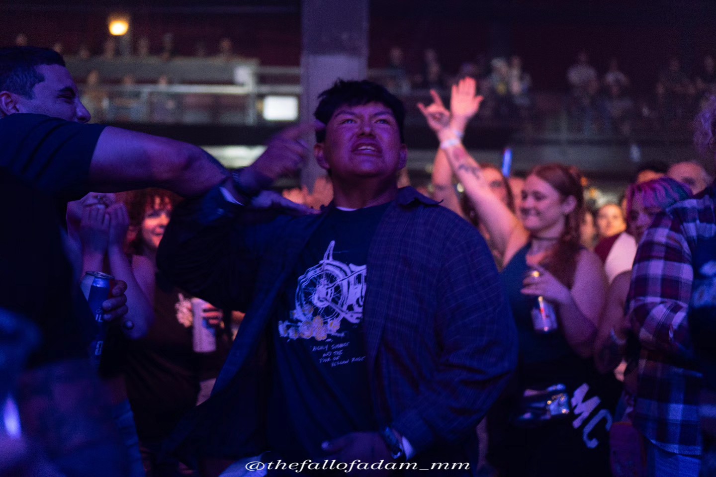 Highly Suspect fans raising their hands under purple lights.