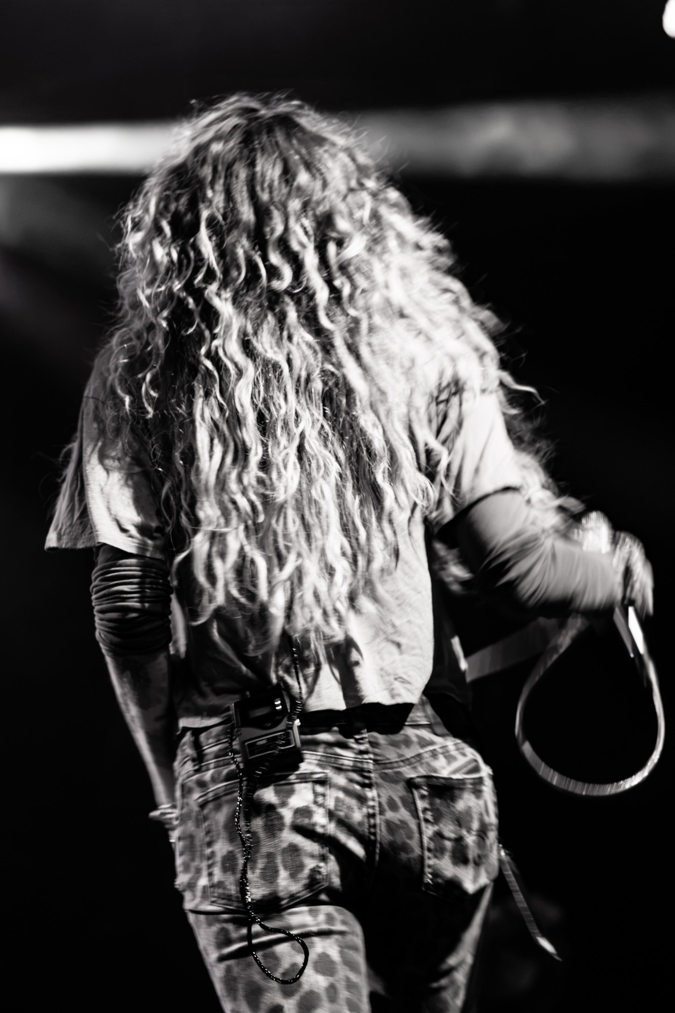 Black and white view of Paris Jackson from behind.