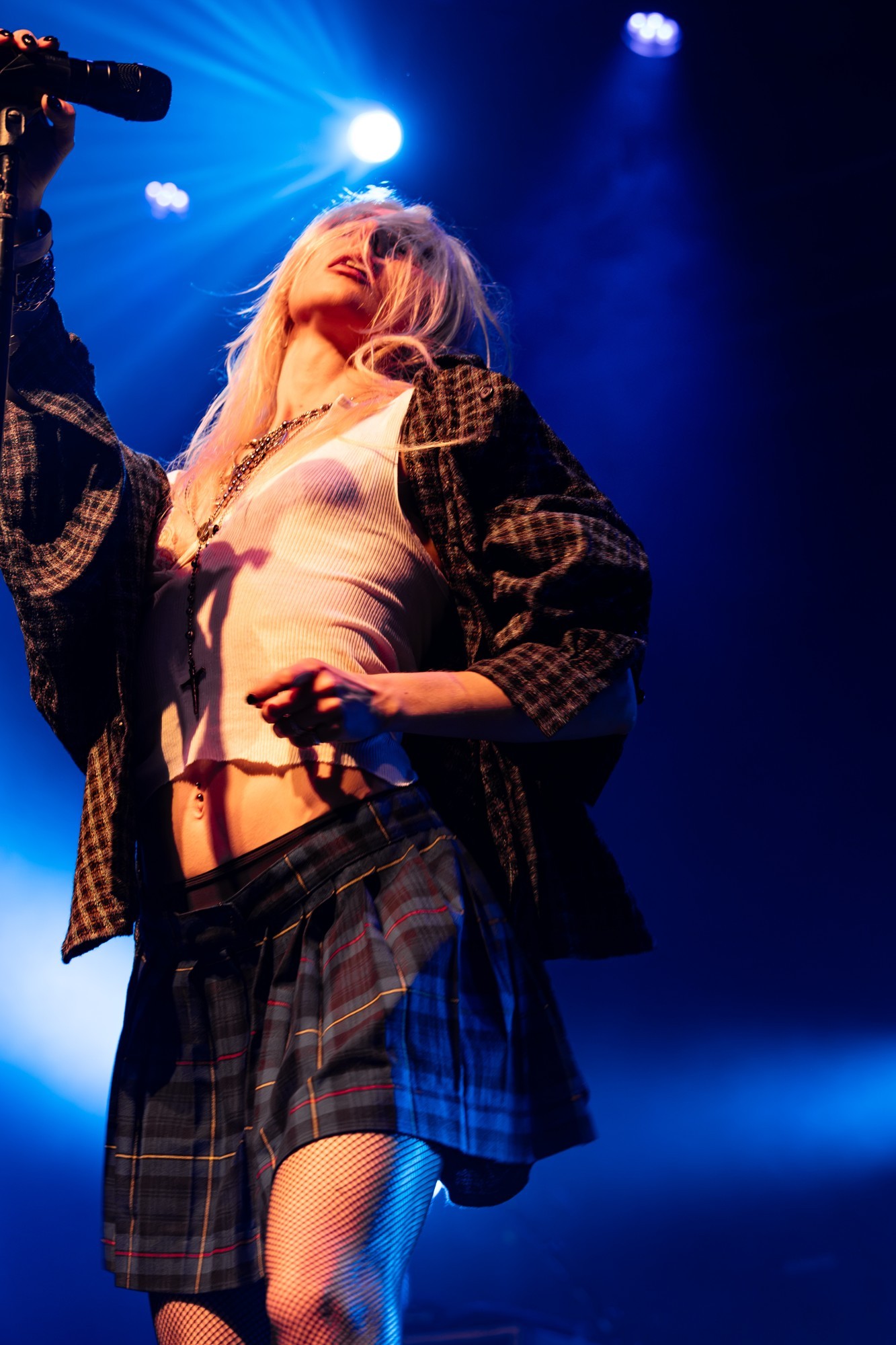 Taylor Momsen performing beside her microphone stand.