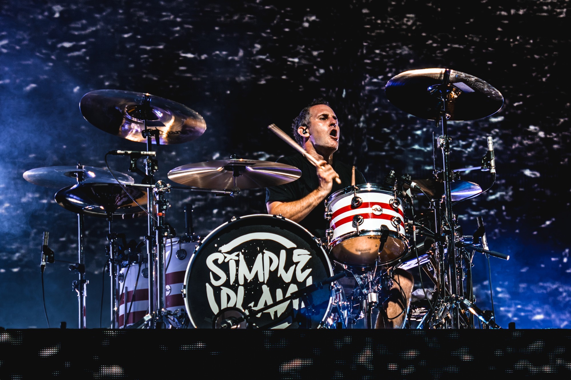 Simple Plan drummer performing behind his kit.