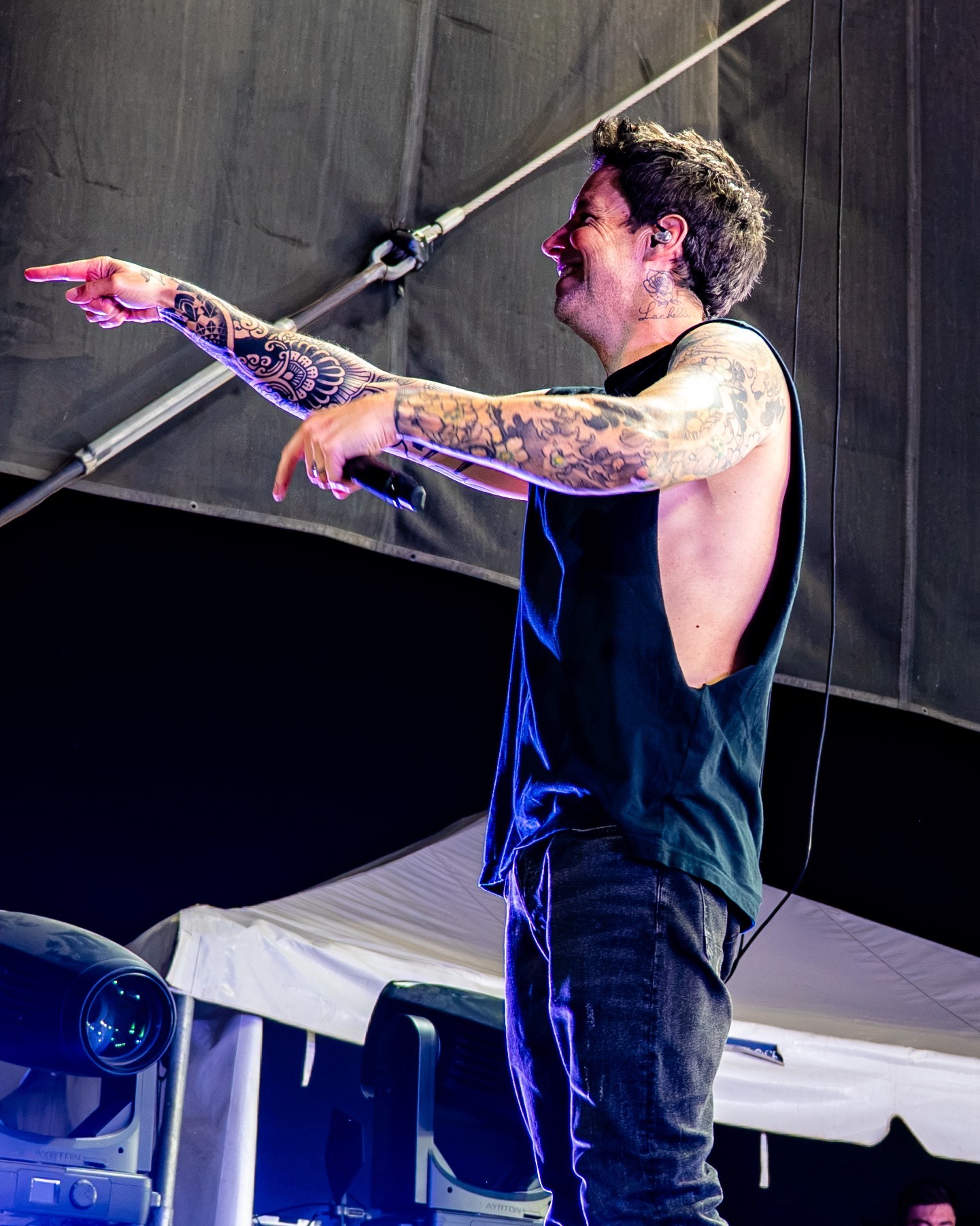 Simple Plan vocalist addressing the crowd from the stage edge.
