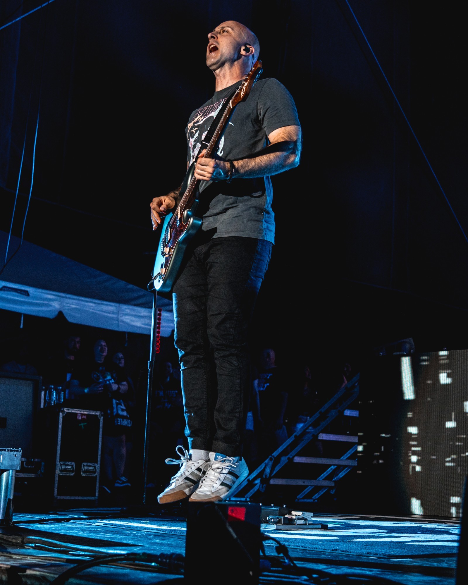 Simple Plan guitarist airborne while performing.