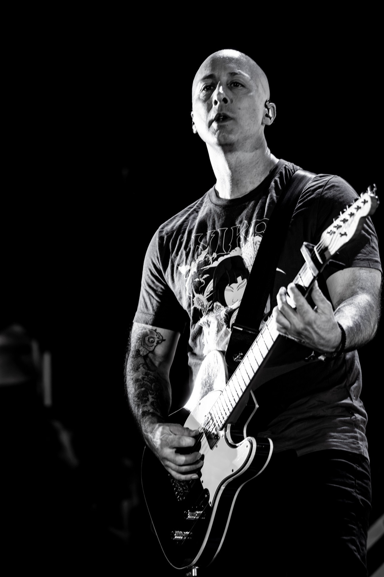 Black and white portrait of a Simple Plan guitarist.