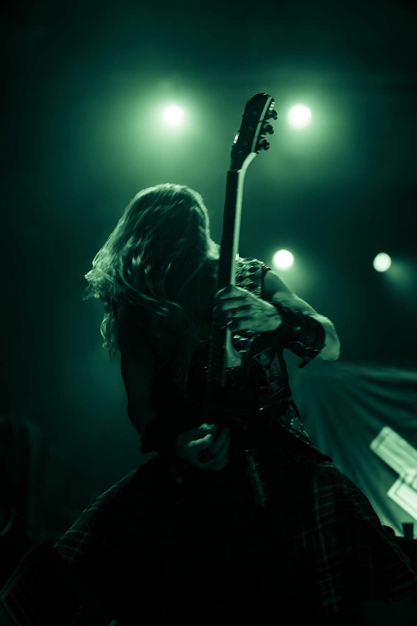 Zakk Sabbath musician silhouetted beneath green lights at The Ritz.