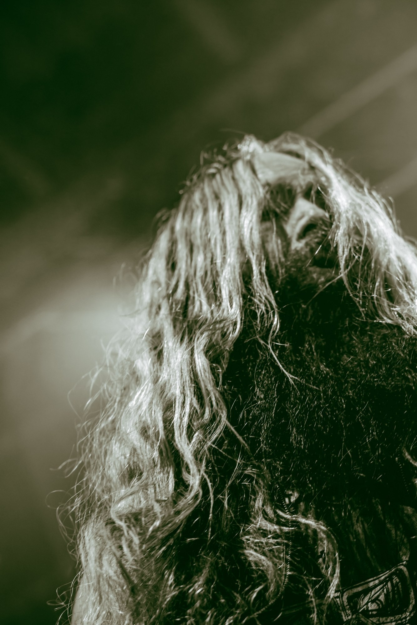 A Zakk Sabbath musician’s hair catching the stage light at The Ritz.